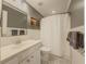 Neutral toned bathroom showcasing a white vanity, classic tile flooring, and shower with curtain at 557 Pringle Dr, Suwanee, GA 30024