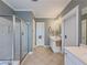 Bathroom featuring a glass-enclosed shower, and double sinks with framed mirrors at 557 Pringle Dr, Suwanee, GA 30024