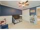 Comfortable bedroom with a dark blue accent wall and a white wainscot at 557 Pringle Dr, Suwanee, GA 30024
