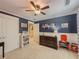 Comfortable bedroom featuring dark blue accent wall and white wainscot at 557 Pringle Dr, Suwanee, GA 30024