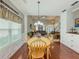 Lovely dining area with hardwood floors and an open view into the living room at 557 Pringle Dr, Suwanee, GA 30024