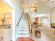 Inviting foyer with hardwood floors, staircase, and an open view into the living room at 557 Pringle Dr, Suwanee, GA 30024