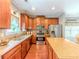 Well-equipped kitchen with stainless steel appliances, granite counters, and warm wood cabinetry at 557 Pringle Dr, Suwanee, GA 30024