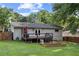The backyard features a wooden deck, garden beds, and a fully fenced yard surrounded by mature trees at 984 Ridgecrest Se Dr, Smyrna, GA 30080