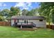 Backyard featuring a wood deck and a spacious lawn with raised garden beds at 984 Ridgecrest Se Dr, Smyrna, GA 30080