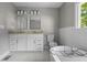Bathroom featuring tub, double vanity, and glass shower enclosure at 984 Ridgecrest Se Dr, Smyrna, GA 30080