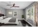 Cozy bedroom with two windows with curtains and dark wood-look laminate flooring at 984 Ridgecrest Se Dr, Smyrna, GA 30080