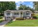 Charming home featuring a well-manicured lawn, inviting porch swing, and stylish architectural details at 984 Ridgecrest Se Dr, Smyrna, GA 30080