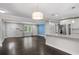 Open-concept living space with hardwood floors and modern lighting flowing from the kitchen at 984 Ridgecrest Se Dr, Smyrna, GA 30080