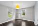 Bright office space with hardwood floors, two windows and shelves with a modern yellow drum light at 984 Ridgecrest Se Dr, Smyrna, GA 30080