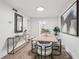 Bright dining room features wood floors, modern light fixture, and table set for six under contemporary art at 1166 Booth Sw Rd # 301, Marietta, GA 30008