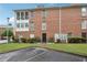 Brick condo with a well-manicured lawn and mature shrubs, showing a welcoming front entrance at 1166 Booth Sw Rd # 301, Marietta, GA 30008