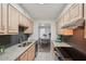 Modern kitchen leads into the dining room; featuring stainless appliances, granite counters, and light wood cabinets at 1166 Booth Sw Rd # 301, Marietta, GA 30008