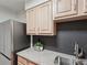 Close-up shot of granite countertop, stainless sink, and light wood cabinetry in the kitchen at 1166 Booth Sw Rd # 301, Marietta, GA 30008