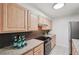 Well-lit kitchen features stainless steel appliances, granite countertops, and light wood cabinetry at 1166 Booth Sw Rd # 301, Marietta, GA 30008