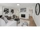 Bright living room with hardwood floors, fireplace, modern decor, and large decorative prints at 1166 Booth Sw Rd # 301, Marietta, GA 30008