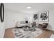 Living room featuring hardwood floors, neutral walls, modern furniture, and decorative wall art at 1166 Booth Sw Rd # 301, Marietta, GA 30008