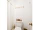 This bathroom features gold accents, a white shower curtain and a white toilet at 1348 Sheffield Glen Ne Way # 8, Atlanta, GA 30329