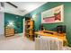 A cozy bedroom with green walls and a guitar-themed decor with a ceiling fan and built in shelving unit at 1348 Sheffield Glen Ne Way # 8, Atlanta, GA 30329