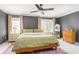 This bedroom offers neutral colors, a ceiling fan, an area rug, and two windows providing natural light at 1348 Sheffield Glen Ne Way # 8, Atlanta, GA 30329