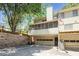 Townhouse exterior featuring a two-car garage, screened porch, and American flag, surrounded by mature trees at 1348 Sheffield Glen Ne Way # 8, Atlanta, GA 30329