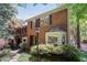 Brick townhouse with manicured front yard landscaping, black shutters and large windows at 1348 Sheffield Glen Ne Way # 8, Atlanta, GA 30329