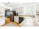 Bright kitchen with stainless steel refrigerator, white cabinets, and a countertop sink under a window at 1348 Sheffield Glen Ne Way # 8, Atlanta, GA 30329