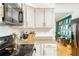 Bright kitchen featuring stainless steel appliances, including a microwave and a mixer on granite countertops at 1348 Sheffield Glen Ne Way # 8, Atlanta, GA 30329