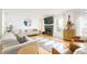 Bright living room with fireplace, hardwood floors, modern furnishings and ample natural light at 1348 Sheffield Glen Ne Way # 8, Atlanta, GA 30329