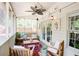 Cozy screened porch with wooden furniture, string lights, and potted plants, perfect for relaxation at 1348 Sheffield Glen Ne Way # 8, Atlanta, GA 30329
