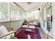 Relaxing screened porch featuring wooden furniture, an area rug, and views of the backyard at 1348 Sheffield Glen Ne Way # 8, Atlanta, GA 30329