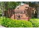 Community entrance sign with brick facade and lush green landscaping at 1348 Sheffield Glen Ne Way # 8, Atlanta, GA 30329