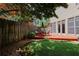Inviting backyard with a wooden deck, dining set, and lush lawn, perfect for outdoor entertaining at 2459 Chestnut Lndg, Atlanta, GA 30360
