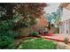 Inviting backyard with a wooden deck, dining set, and lush lawn, surrounded by trees and shrubs at 2459 Chestnut Lndg, Atlanta, GA 30360