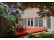 Charming backyard with a wooden deck, dining area, and lush greenery, perfect for relaxation and outdoor gatherings at 2459 Chestnut Lndg, Atlanta, GA 30360
