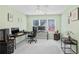 Bedroom offering a dedicated workspace with multiple monitors, a sleek desk, and ample natural light from a window at 2459 Chestnut Lndg, Atlanta, GA 30360