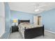 Charming bedroom with blue walls, a ceiling fan, and a comfortable bed with floral patterned bedding at 2459 Chestnut Lndg, Atlanta, GA 30360