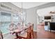 Inviting dining area with natural light, table set for six, and connecting living room at 2459 Chestnut Lndg, Atlanta, GA 30360