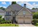 Charming two-story home featuring a manicured lawn, two-car garage, and neutral color scheme at 2459 Chestnut Lndg, Atlanta, GA 30360