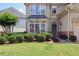 Close-up of landscaped front yard with manicured bushes and lush green grass at 2459 Chestnut Lndg, Atlanta, GA 30360