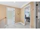 Upstairs hallway with neutral colors and access to multiple rooms and bathrooms, offering a comfortable transition at 2459 Chestnut Lndg, Atlanta, GA 30360