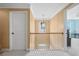 Upstairs hallway with modern railing, lighting, and neutral walls, offering access to multiple rooms at 2459 Chestnut Lndg, Atlanta, GA 30360