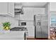 A modern kitchen features stainless steel appliances and white cabinets at 2459 Chestnut Lndg, Atlanta, GA 30360