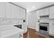 Bright kitchen with white cabinets, stainless steel appliances, and tiled backsplash at 2459 Chestnut Lndg, Atlanta, GA 30360