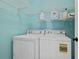 Convenient laundry room with washer, dryer, and storage shelves, perfect for efficient home management at 2459 Chestnut Lndg, Atlanta, GA 30360
