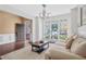 Bright living room features hardwood floors, white trim, large windows, and a comfortable couch at 2459 Chestnut Lndg, Atlanta, GA 30360