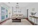 Cozy living room featuring hardwood floors, white trim, natural light, and comfortable seating at 2459 Chestnut Lndg, Atlanta, GA 30360