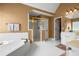 Spacious main bathroom with a large tub, glass shower, and dual sink vanities, perfect for relaxation at 2459 Chestnut Lndg, Atlanta, GA 30360