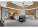 Spacious main bedroom boasts a trey ceiling, ceiling fan, and multiple windows allowing for natural light at 2459 Chestnut Lndg, Atlanta, GA 30360