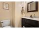 Elegant powder room featuring a dark vanity with a white countertop, decorative mirror, and a modern faucet at 2459 Chestnut Lndg, Atlanta, GA 30360